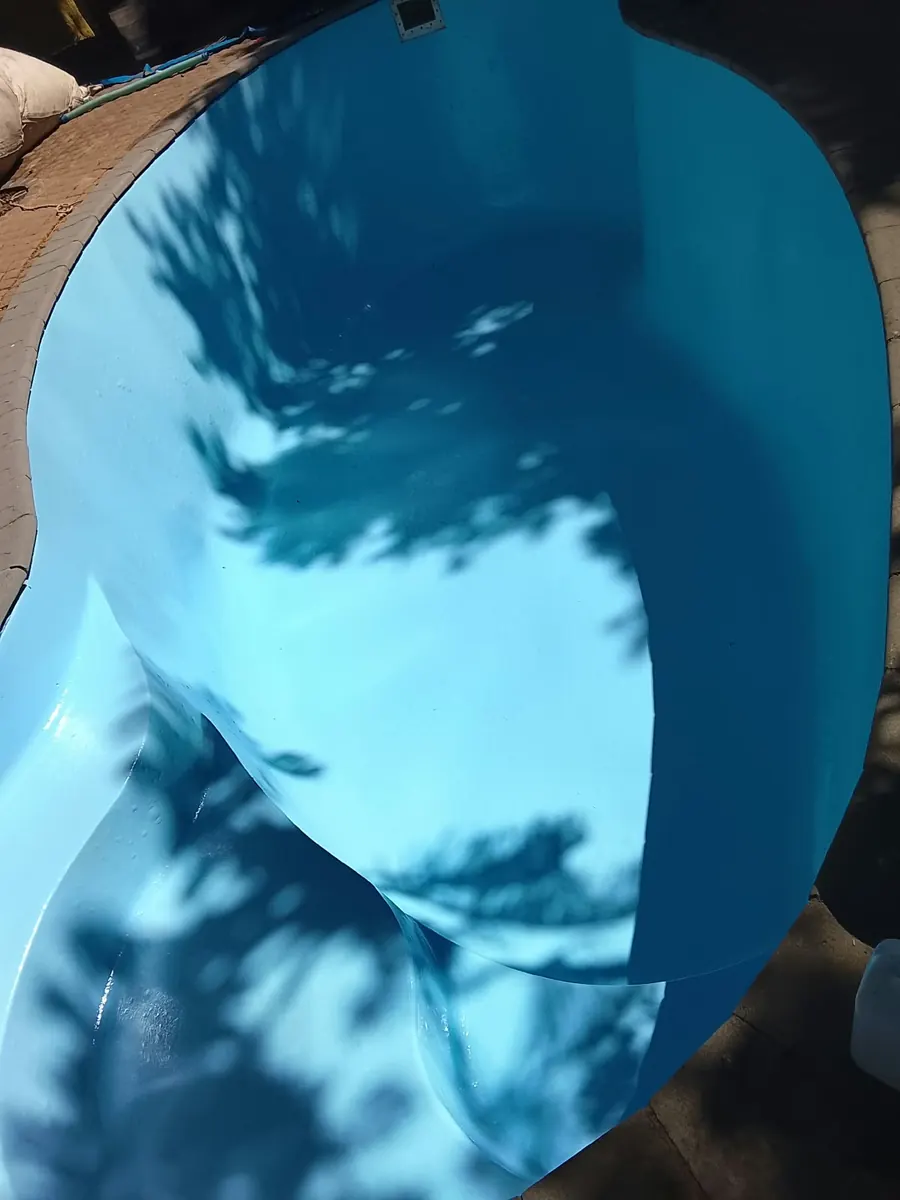 An empty pool freshly painted bright blue